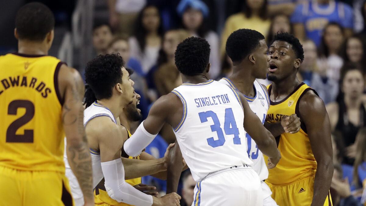 Arizona State guard Luguentz Dort, right, argues with UCLA guard Kris Wilkes, second from right, during the second half.