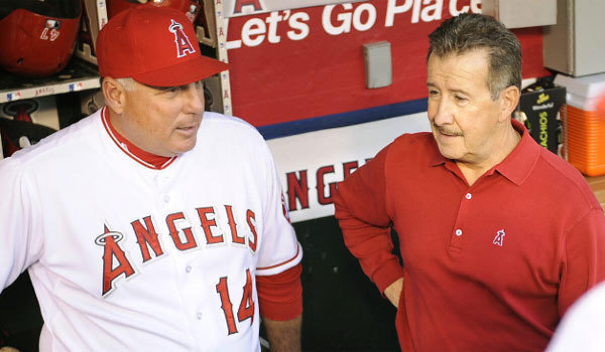 Angels owner Arte Moreno, right, says Manager Mike Scioscia isn't going anywhere.