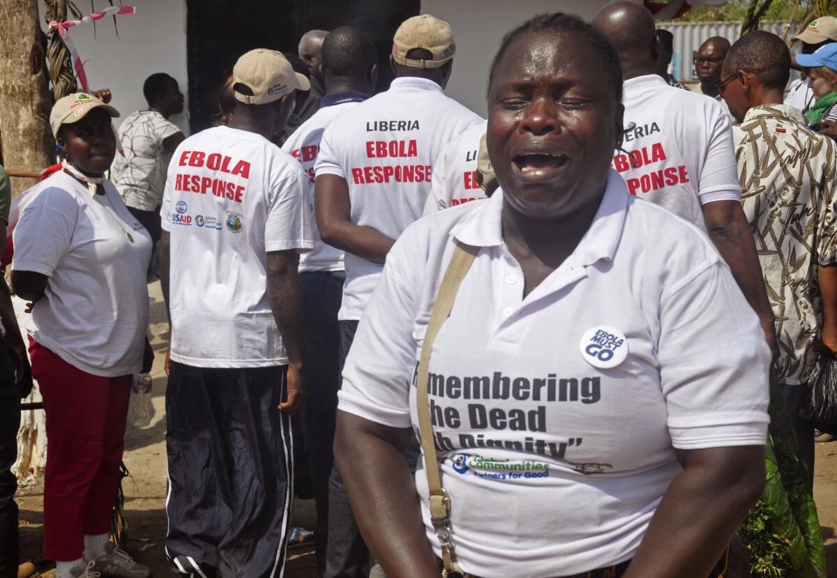 A woman cries Wednesday at a crematorium in Monrovia, Liberia, as she commemorates a loved one who died of Ebola.