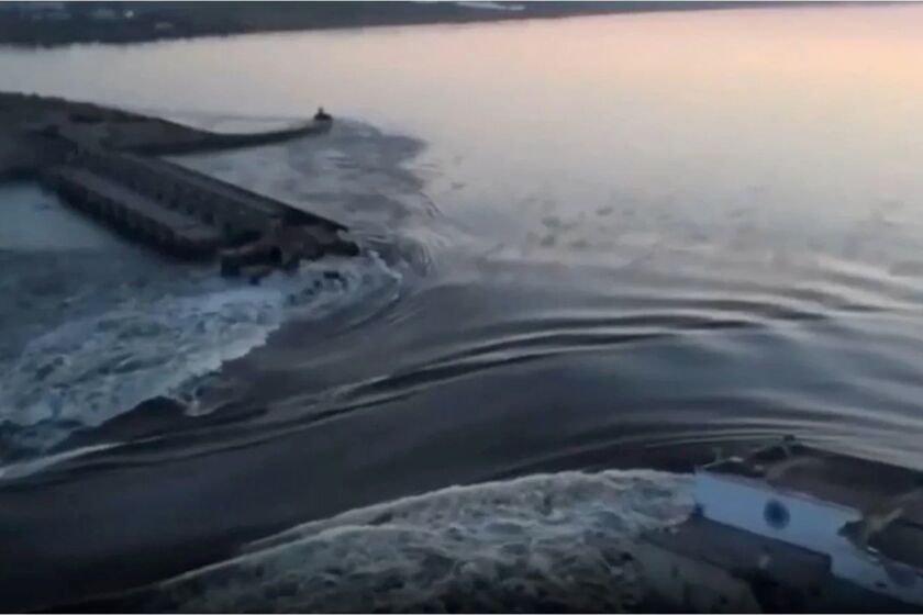 In this image taken from video released by the Ukrainian Presidential Office, water runs through a breakthrough in the Kakhovka dam in Kakhovka, Ukraine, Tuesday, June 6, 2023. Ukraine on Tuesday accused Russian forces of blowing up the major dam and hydroelectric power station in a part of southern Ukraine they control, threatening a massive flood that could displace hundreds of thousands of people, and ordered residents downriver to evacuate. (Ukrainian Presidential Office via AP)