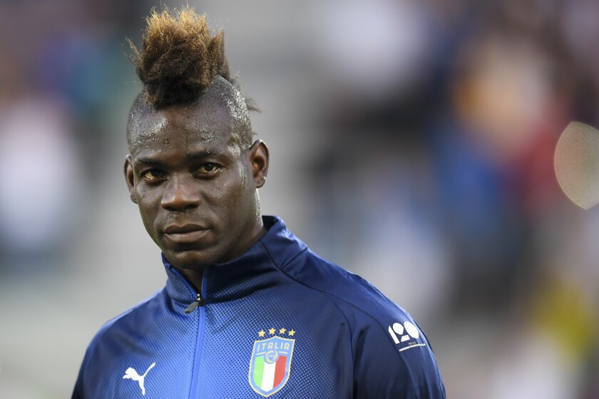 FILE - Italy's Mario Balotelli prior to the start of the friendly soccer match between Saudi Arabia and Italy at Kybunpark Stadium, in St. Gallen, Switzerland, May 28, 2018. Mario Balotelli is back in the Italy squad more than three years after his last appearance in an Azzurri shirt. Italy coach Roberto Mancini included the striker in a 35-man squad announced Monday Jan. 24, 2022, for a three-day training camp this week, ahead of the World Cup playoffs in March. (Gian Ehrenzeller/Keystone via AP, File)