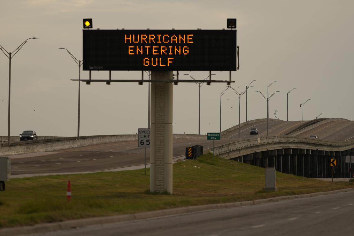 A large digital traffic sign reads in all caps "Hurricane entering Gulf." 