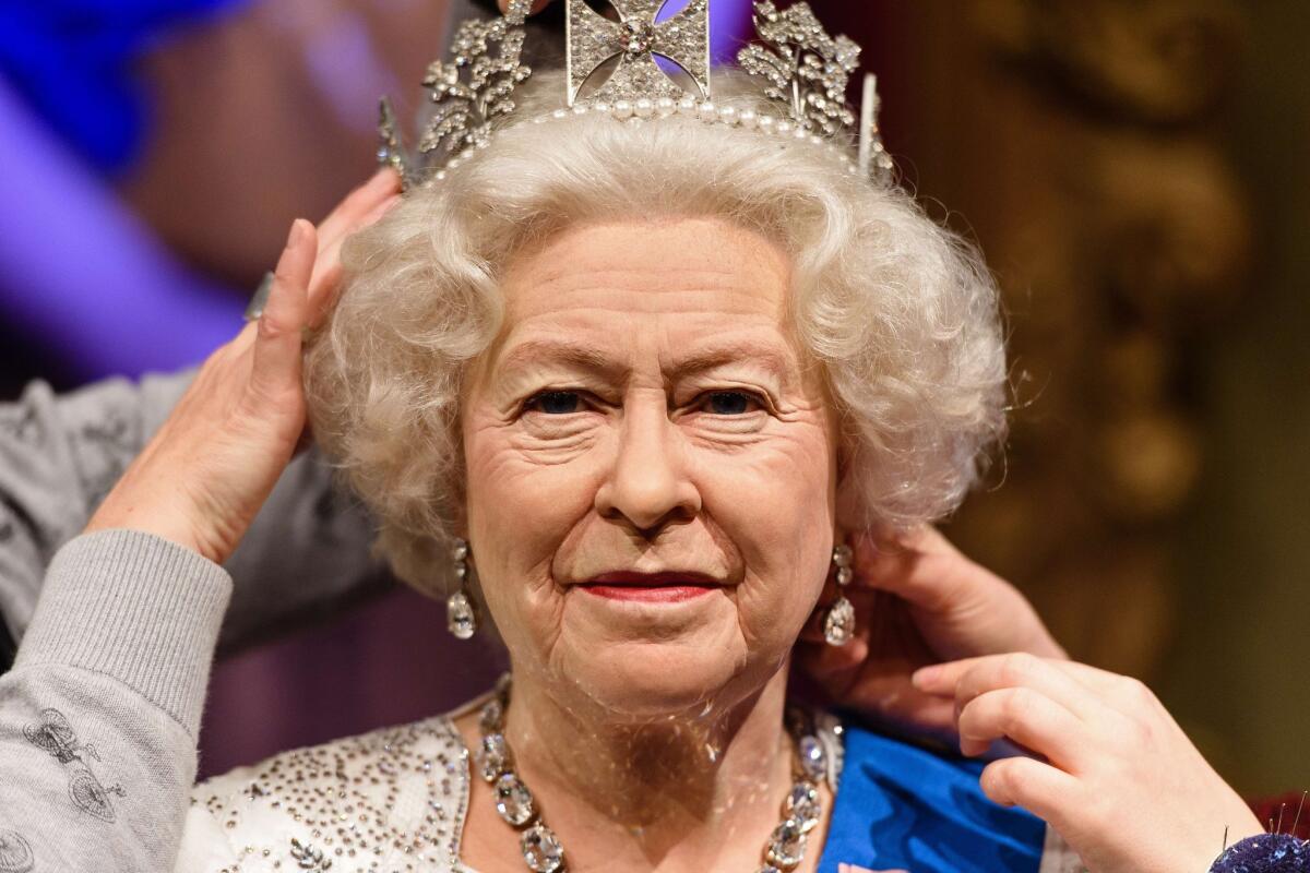 This is not Queen Elizabeth II, though it's a convincing likeness. It's her double at Madame Tussauds London.