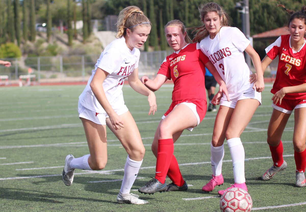 The Dons' Delaney Diltz (5) battles Ella Emri and O'Coyne of Torrey Pines.