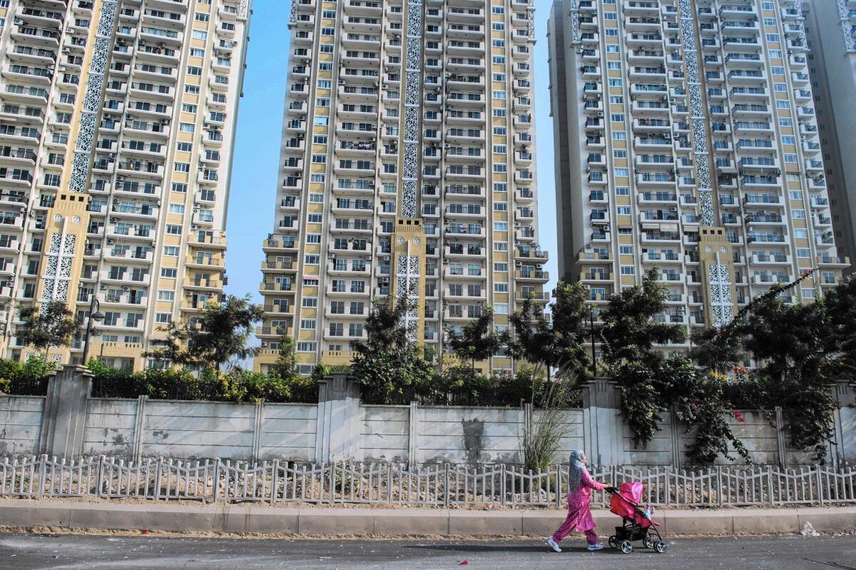 A new residential apartment building near New Delhi. The global population is expected to reach 8.5 billion by 2030.