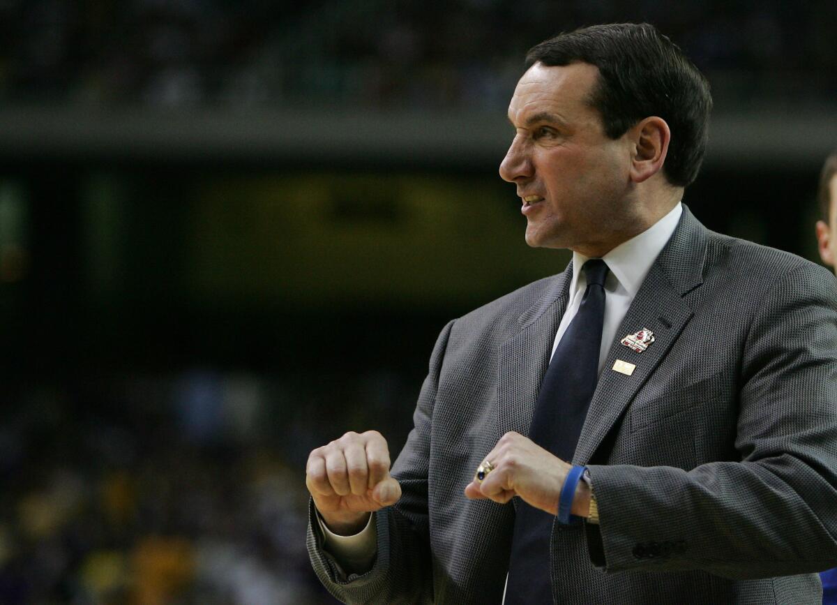 Mike Krzyzewski talks to his players during the NCAA tournament regional semifinal against Louisiana State in Atlanta on March 23, 2006.