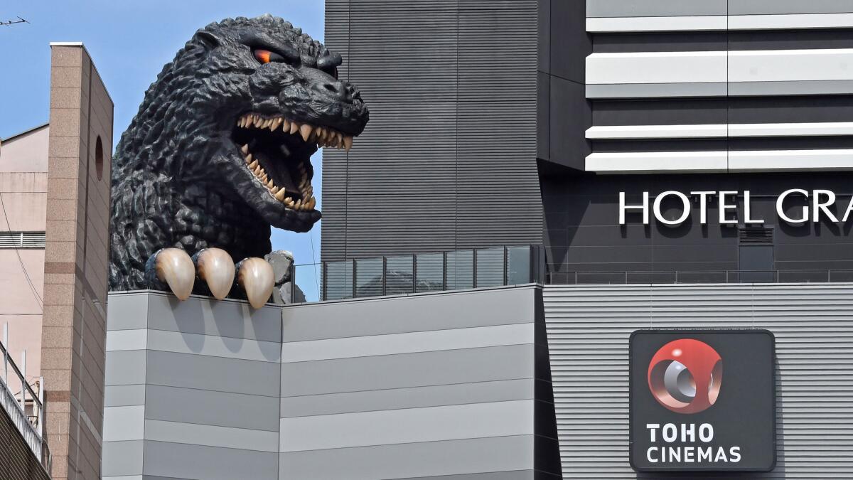A life-size Godzilla head appears on the Hotel Gracery Shinjuku at the Kabukicho shopping district in Tokyo. The Godzilla head is a main feature of the new commercial complex.