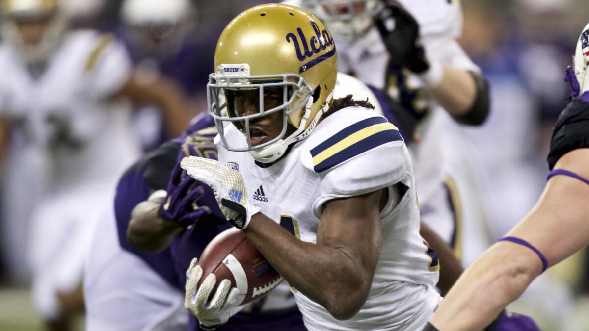 UCLA running back Paul Perkins runs with the ball during the first half of a win over Washington on Nov. 8.