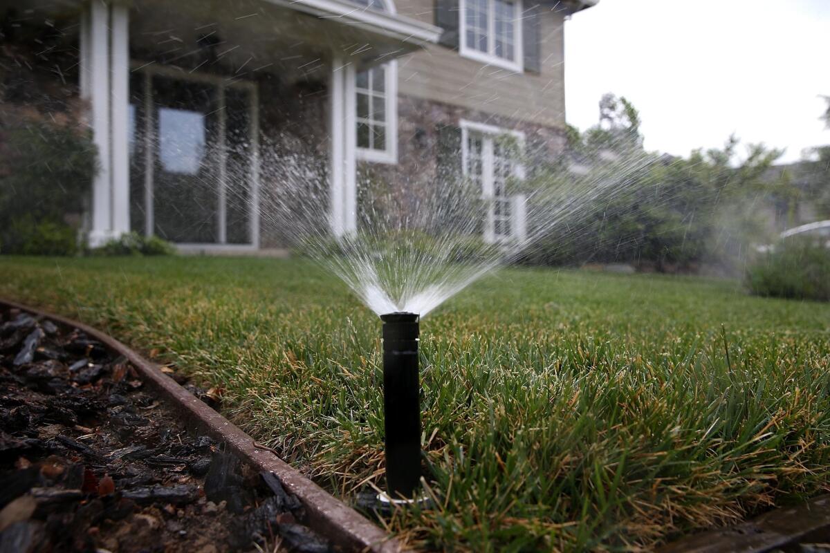A sprinkler waters a lawn on April 7 in Walnut Creek, Calif.