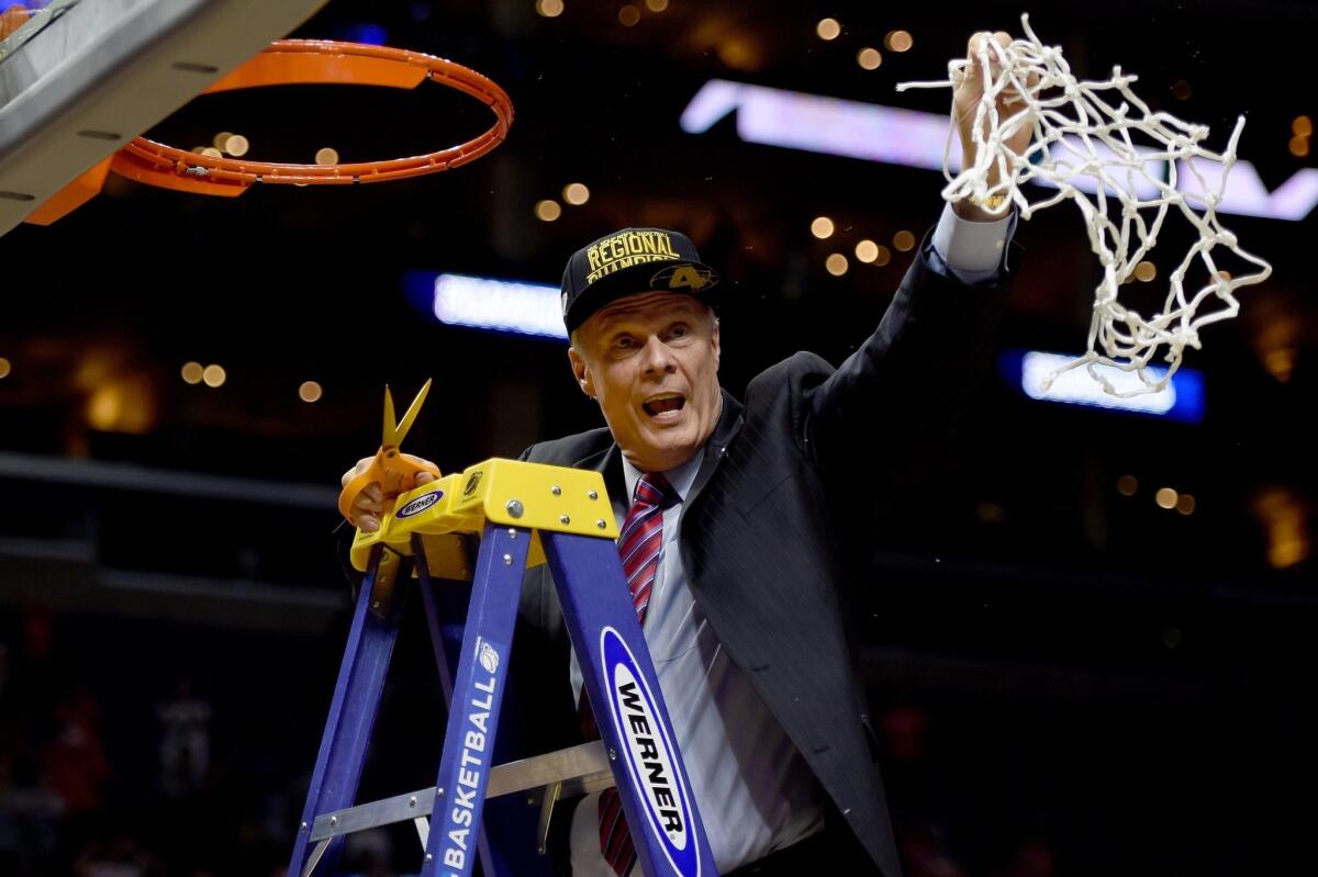Wisconsin Coach Bo Ryan cuts the net after the Badgers' 85-78 victory against the Arizona Wildcats during the West Regional Final of the NCAA tournament March 28 at Staples Center.