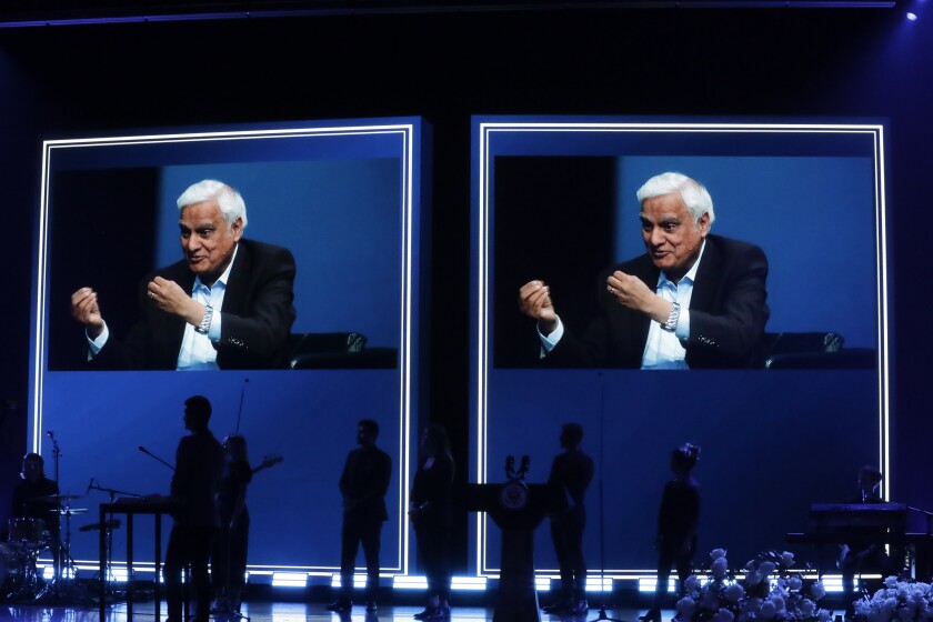 FILE - In this May 29, 2020 file photo, images of Ravi Zacharias are displayed in the Passion City Church during a memorial service for him in Atlanta. A posthumous sex scandal involving Zacharias, who founded the Ravi Zacharias International Ministries has placed the global organization in a wrenching predicament. (AP Photo/Brynn Anderson, File)