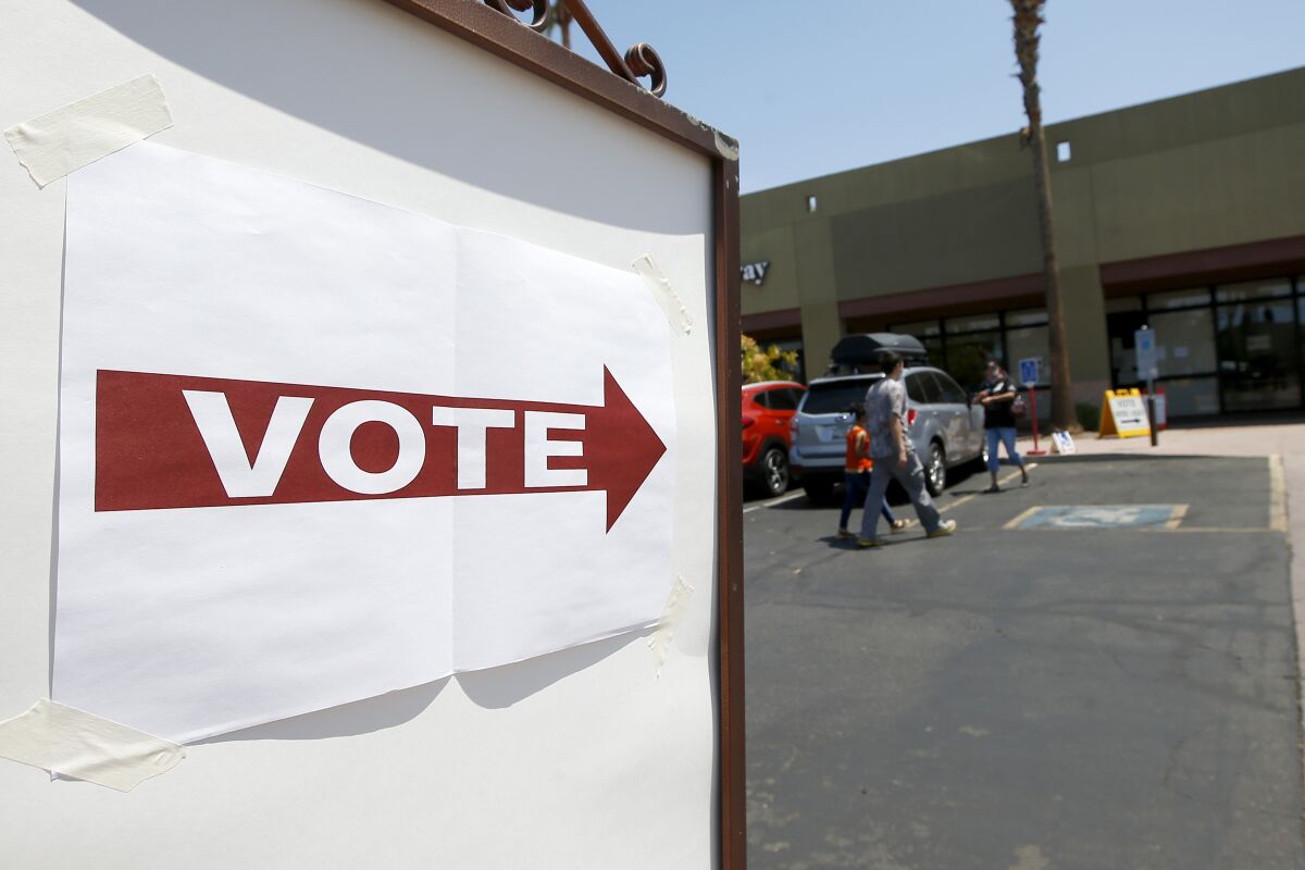 Voters walk to a polling station to cast votes for GOP and Democratic primary candidates Tuesday, Aug. 4, 2020, in Chandler, Ariz. (AP Photo/Ross D. Franklin)