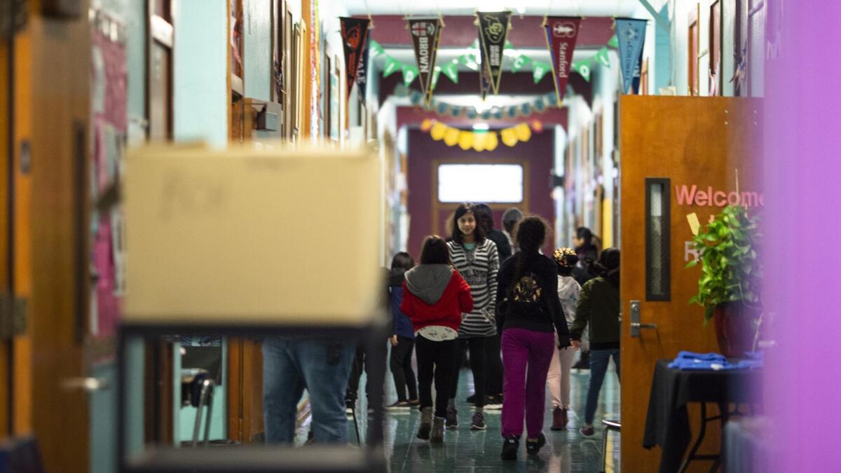 Students are seen in the hallway of Elysian Heights Elementary school as educators, students and parents picket outside on Tuesday.