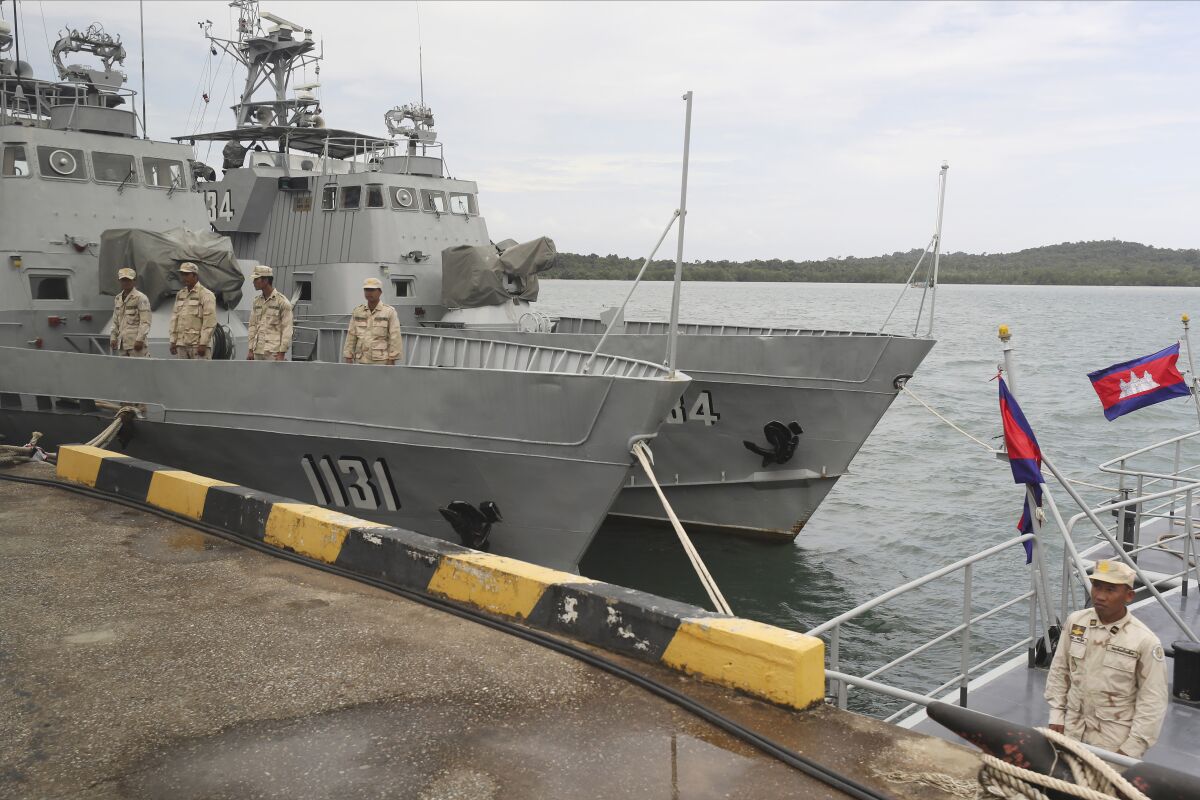 FILE - Cambodian navy crew stand on a patrol boat at the Ream Naval Base in Sihanoukville, southwest of Phnom Penh, Cambodia, July 26, 2019. Cambodian and Chinese officials will break ground this week on the expansion of a port facility that the U.S. and others have worried will be used by Beijing a naval outpost on the Gulf of Thailand, but the government again denied Tuesday that any Chinese military presence would be allowed. (AP Photo/Heng Sinith, File)