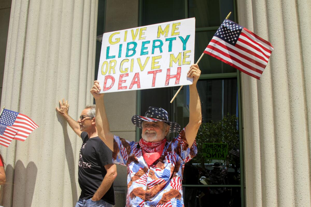 Hundreds of protesters gathered in downtown San Diego to demand that California reopen on May 1, 2020.