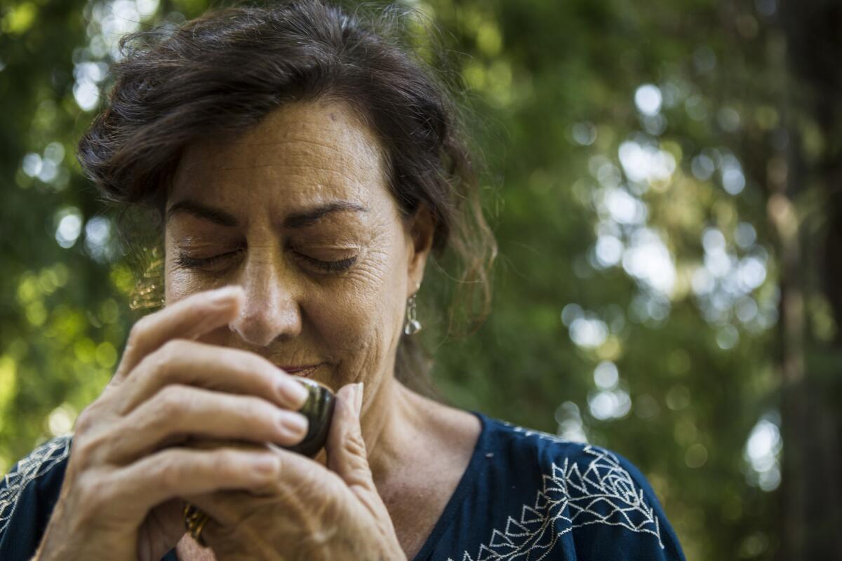 Kate Sullivan whispers an offering to a cup of tea at the end of class.