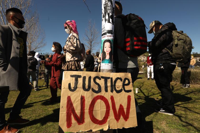 LOS ANGELES, CA - People attend a,"Rally Against Anti-Asian Hate Crimes & Racism," to raise awareness of anti-Asian violence at Los Angeles State Historic Park on February 20, 2021. Ee Lee, featured on the pole, was raped and murdered in Washington Park, Milwaukee in September of 2020. Two Milwaukee teenagers face homicide charges in her death. The rally was organized in part in response to last month's fatal assault of Vicha Ratanapakdee, an 84-year-old immigrant from Thailand, in San Francisco. The rally included hate crime survivors and local Asian elder community members. (Genaro Molina / Los Angeles Times)