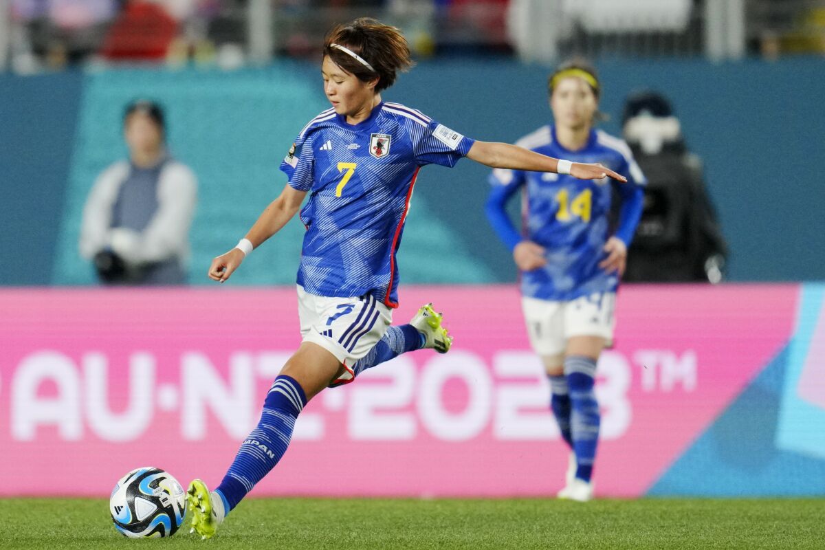 A Japanese soccer player passes the ball