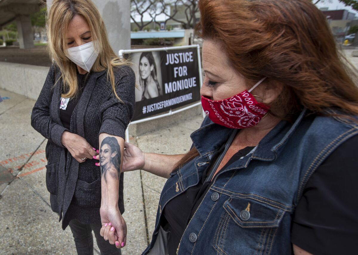  Caroline Crespin, left, mother of Monique Munoz, shows her tattoo of her daughter.