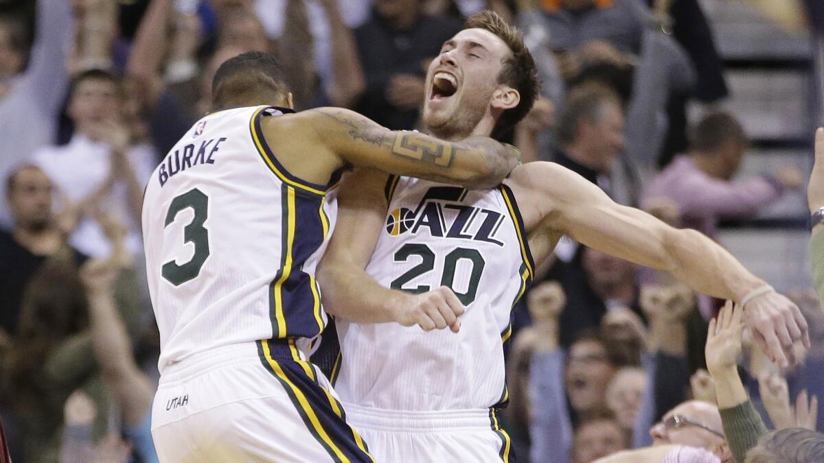 Utah Jazz forward Gordon Hayward, right, celebrates with teammate Trey Burke after scoring the winning basket at the buzzer in a 102-100 win over the Cleveland Cavaliers on Wednesday.