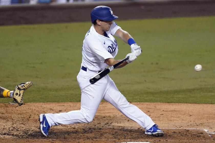 Los Angeles Dodgers' Austin Barnes drives in a run with a single during the fifth inning.
