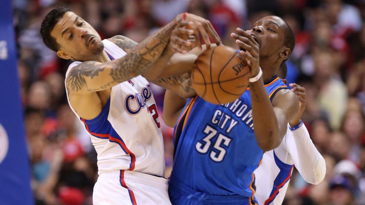 Clippers forward Matt Barnes, left, and Oklahoma City Thunder forward Kevin Durant battle for the ball during Game 4 of the NBA Western Conference semifinals on Sunday.
