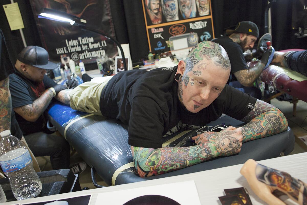 Kyle Phares of Murrieta gets a tattoo by artist Mario Guerrero.