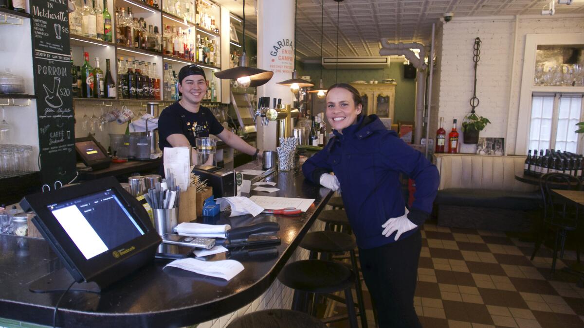 Liam Pierce and Jessica Friedman on each side of the bar at Dante in New York City.