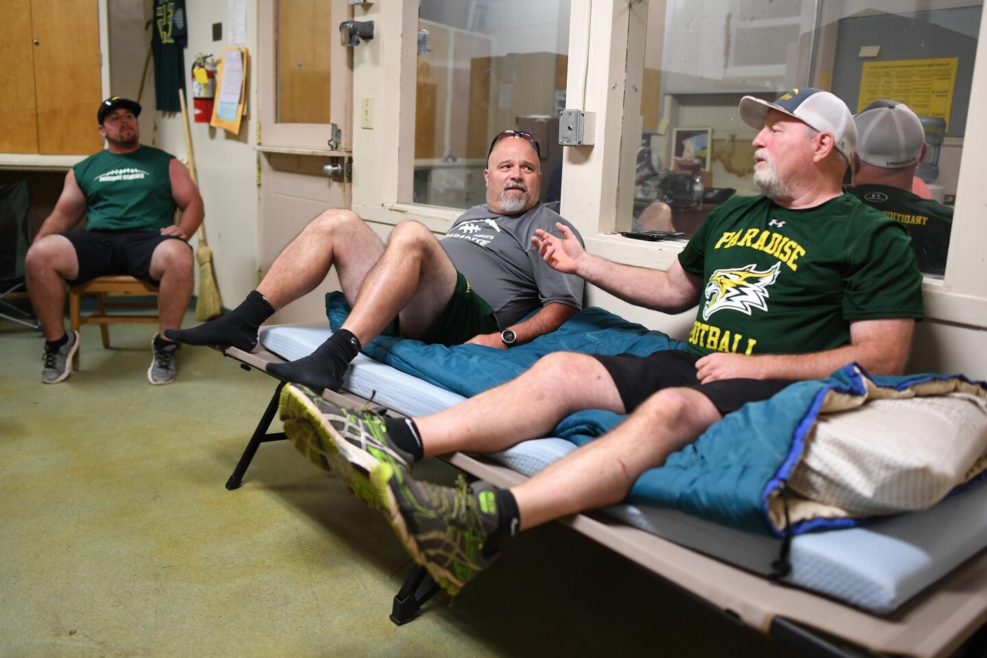 Paradise coach coach Rick Prinz, right, speaks with assistants Bobby Richards, left, and Nino Pinocchio in his office.