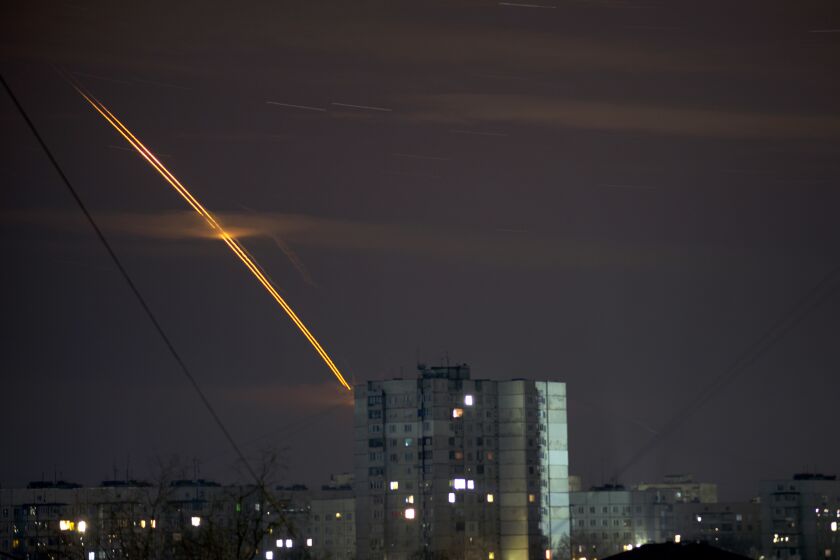 Russian rockets launched against Ukraine from Russia's Belgorod region streak across the sky at dawn in Kharkiv, Ukraine, early Friday, March 24, 2023. (AP Photo/Vadim Belikov)