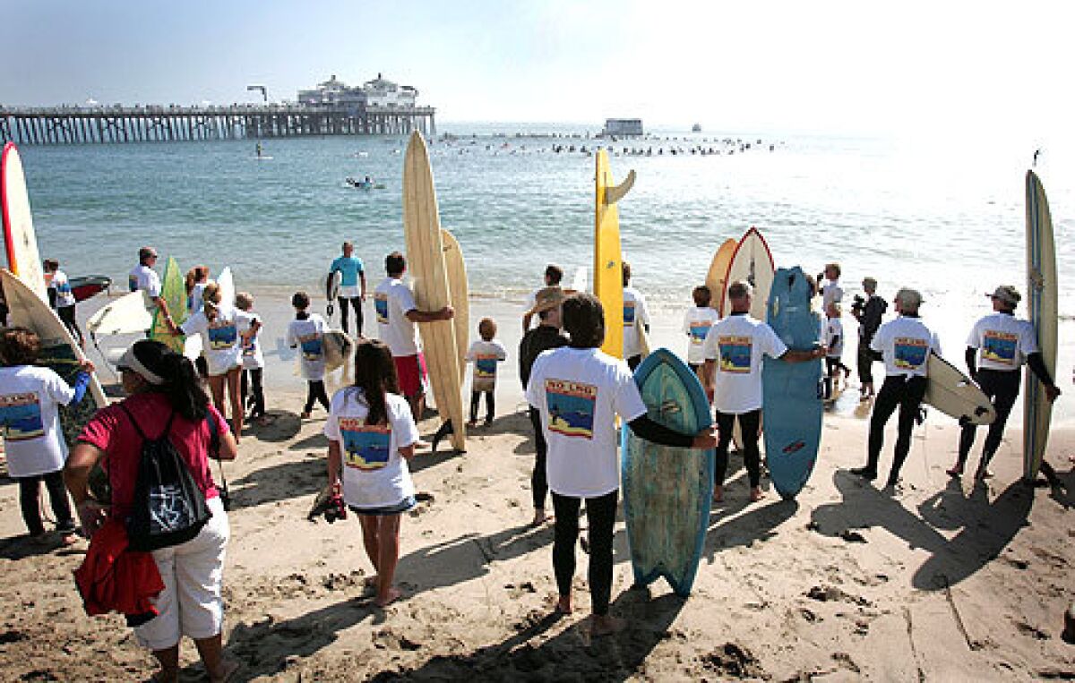 Ready to Get Wet: Demonstrators wait for their colors to be called before joining the protest circle off the Malibu Pier. Actress Daryl Hannah was among those who paddled out.