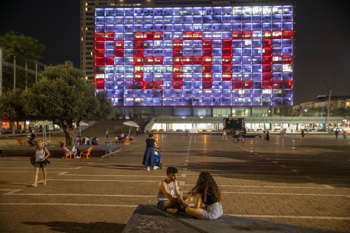 Tel Aviv City Hall is lit up with the words for peace in Hebrew, Arabic and English in honor of the recognition agreements Israel will be signing with the United Arab Emirates and Bahrain at the White House, in Tel Aviv, Israel, Tuesday, Sept. 15, 2020. (AP Photo/Oded Balilty)