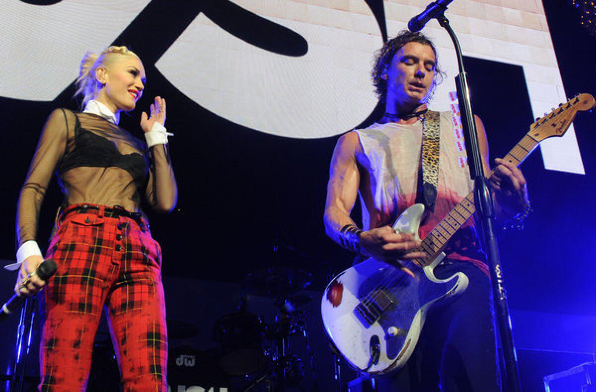 Gwen Stefani joins Gavin Rossdale of Bush for a performance at KROQ-FM's Almost Acoustic Christmas concert on Saturday night.