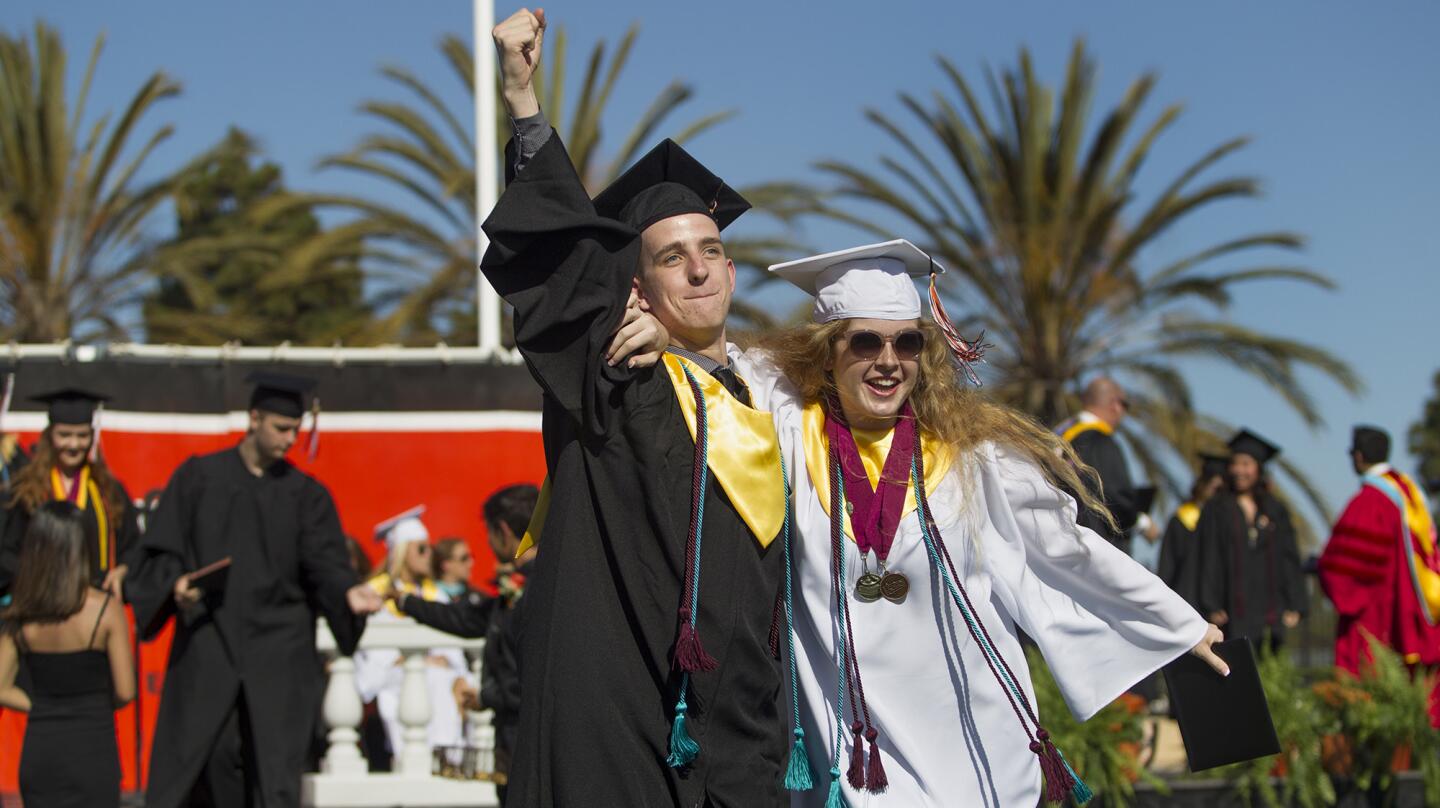 Adam Blanchard and Hannah Thornhill collet their diplomas during Huntington Beach High School's Class of 2017 commencement ceremony on Thursday. (Kevin Chang/ Daily Pilot)