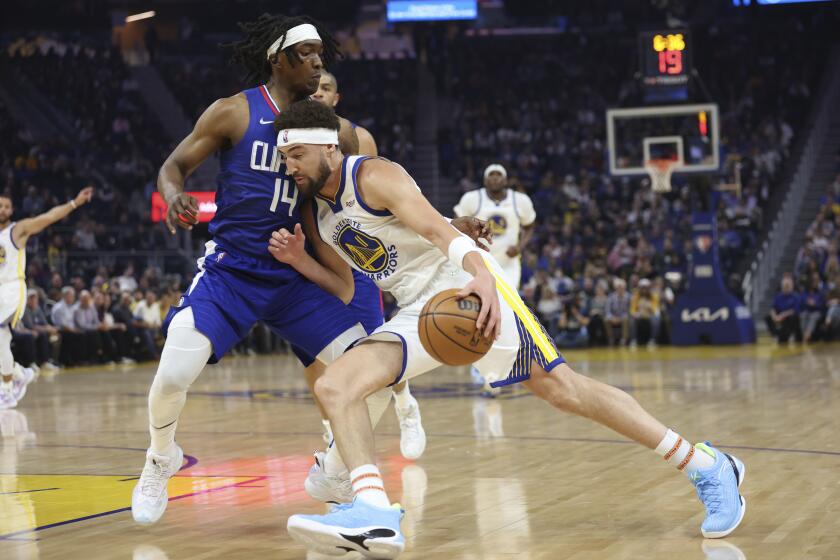 Golden State Warriors guard Klay Thompson (11) drives to the basket against Los Angeles Clippers guard Terance Mann (14) during the first half of an NBA basketball game in San Francisco, Tuesday, March 8, 2022. (AP Photo/Jed Jacobsohn)
