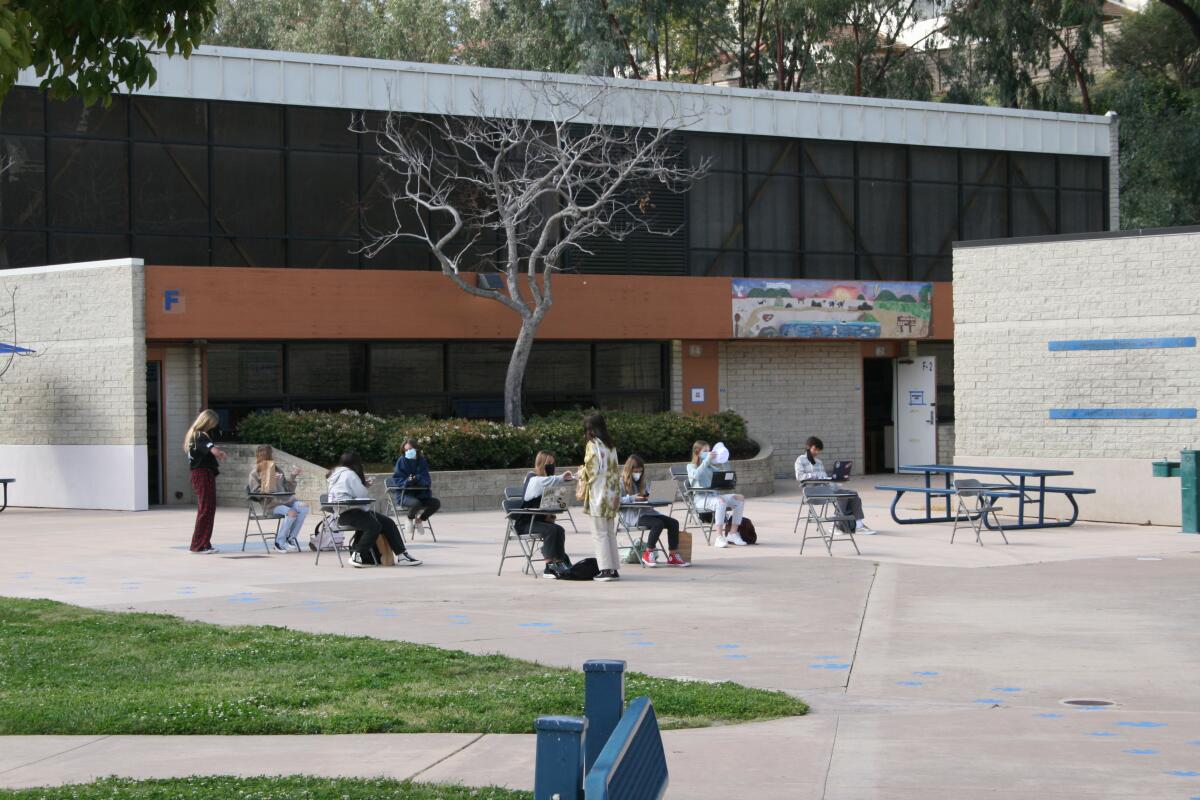 Students engage in an outdoor classroom on the first day return to school at Diegueno Middle School.
