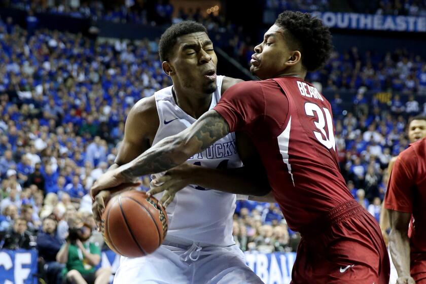 Kentucky center Dakari Johnson tries to drive to the basket against Arkansas guard Anton Beard in the second half Sunday.