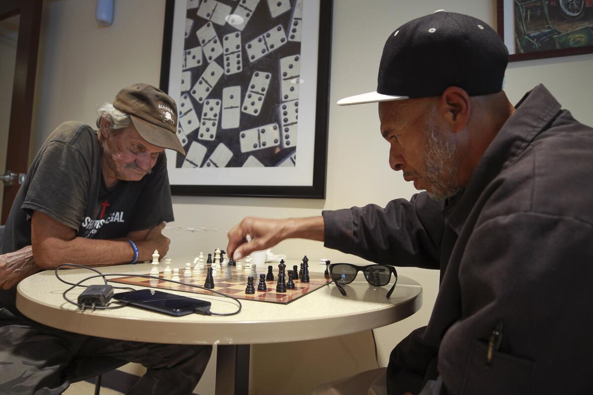 Yusuf Najeeullah, 65, right, plays Paul Piatek, 70, in a game of chess while in the game room at the Gary and Mary West Senior Wellness Center on Tuesday, October 15, 2019 in San Diego, California.