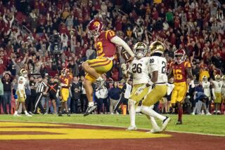 USC quarterback Caleb Williams runs for his third touchdown of the game against Notre Dame on Nov. 26, 2022.