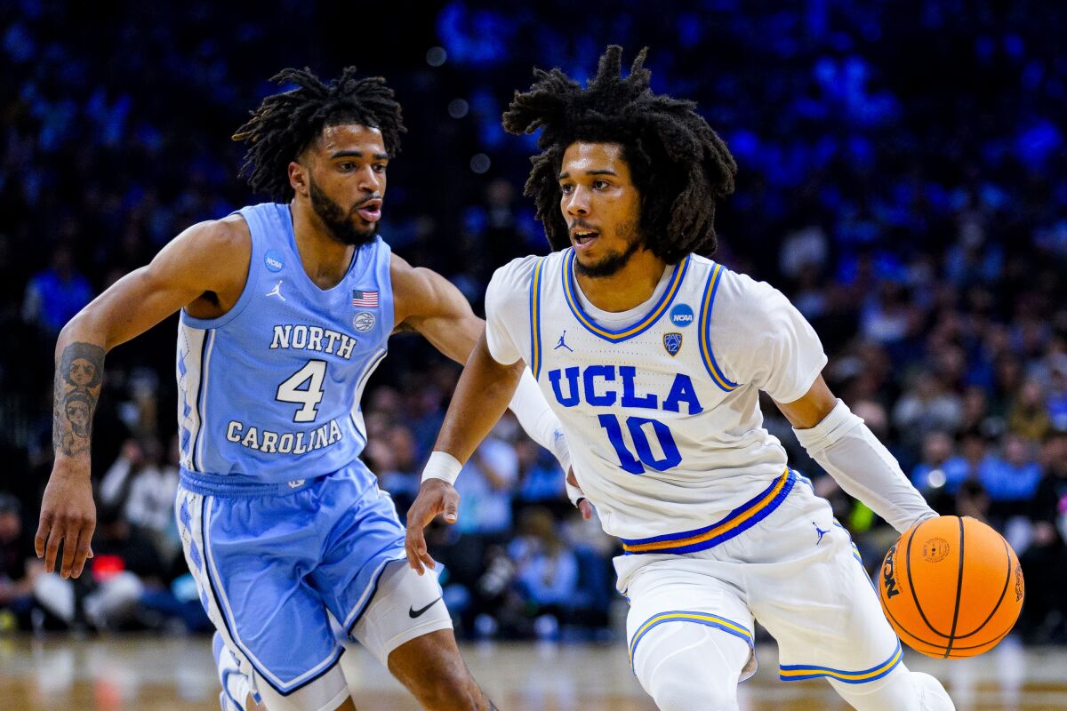 UCLA point guard Tyger Campbell drives against North Carolina's RJ Davis during a Sweet 16 game March 25.