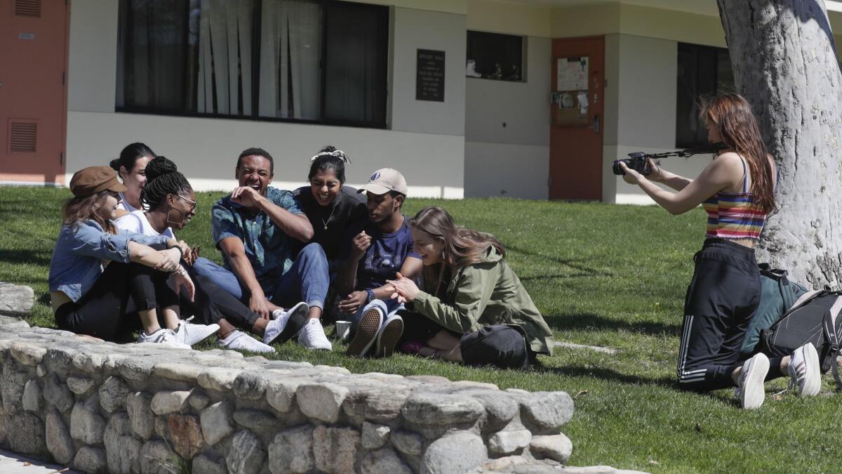 Friends of Claremont McKenna student Kendall Hollimon surround him for a campus video shoot. Hollimon is a nationally ranked diver.