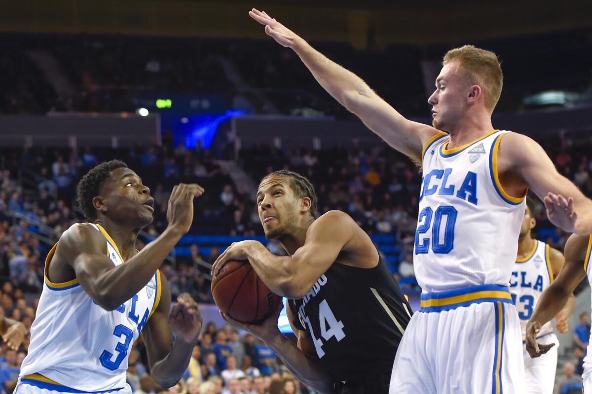 Colorado guard Josh Fortune (44) drives on UCLA guards Aaron Holiday (3) and Bryce Alford (20) during the first half of a game on Feb. 20.