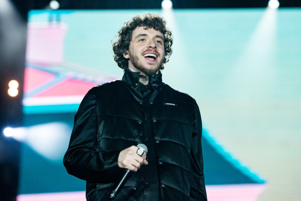 Jack Harlow holds a microphone while on stage at Rolling Loud