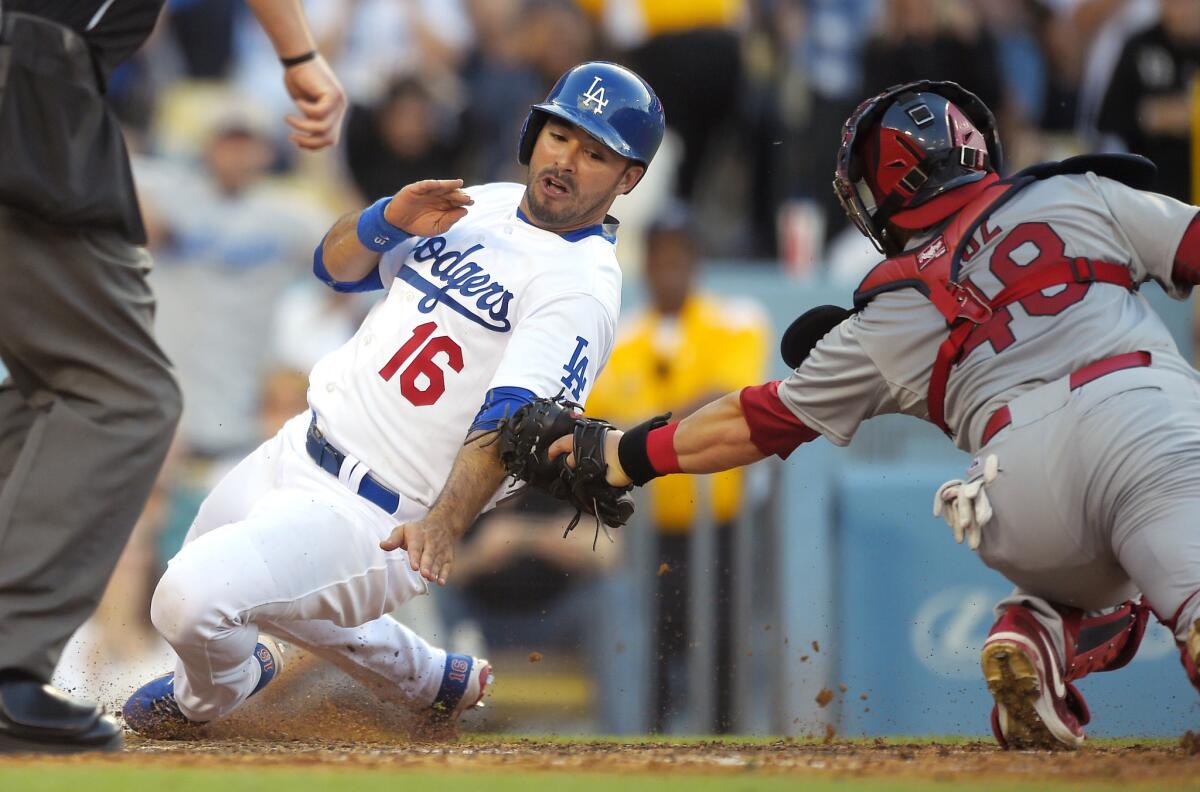 Dodgers left fielder Andre Ethier (16) is tagged out by Cardinals catcher Tony Cruz while trying to score on a single to right field by Jimmy Rollins in the sixth inning Sunday night.