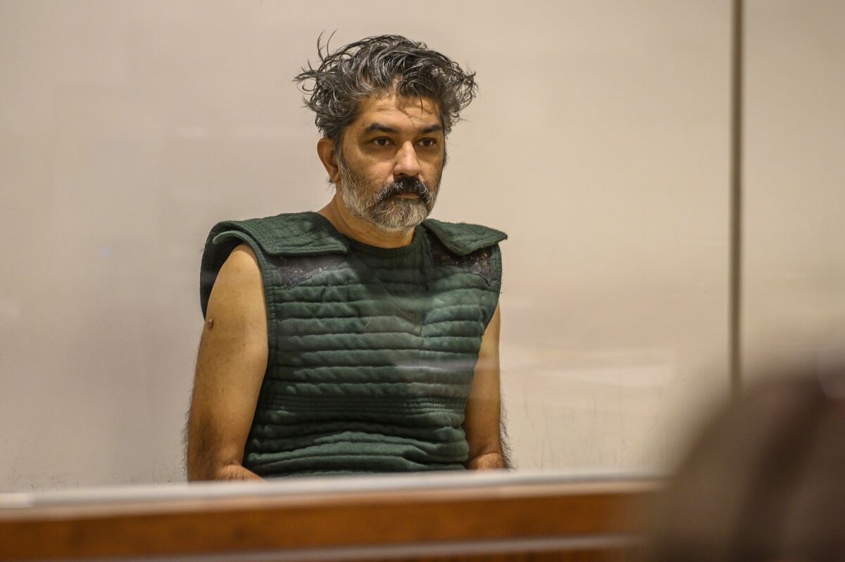 FILE - In this Oct. 16, 2019, file photo, Shankar Hangud, wearing a personal safety vest, appears in the Placer County Superior Court in Roseville, Calif. Hangud, 55, who confessed to killing his wife and three sons in 2019, was sentenced Wednesday, Nov. 10, 2021, to life in prison without parole. Placer County Superior Court Judge Jeffrey Penney called it a "horrific crime," as he sentenced Hangud to three life prison terms. (Renee C. Byer/The Sacramento Bee via AP, Pool, File)
