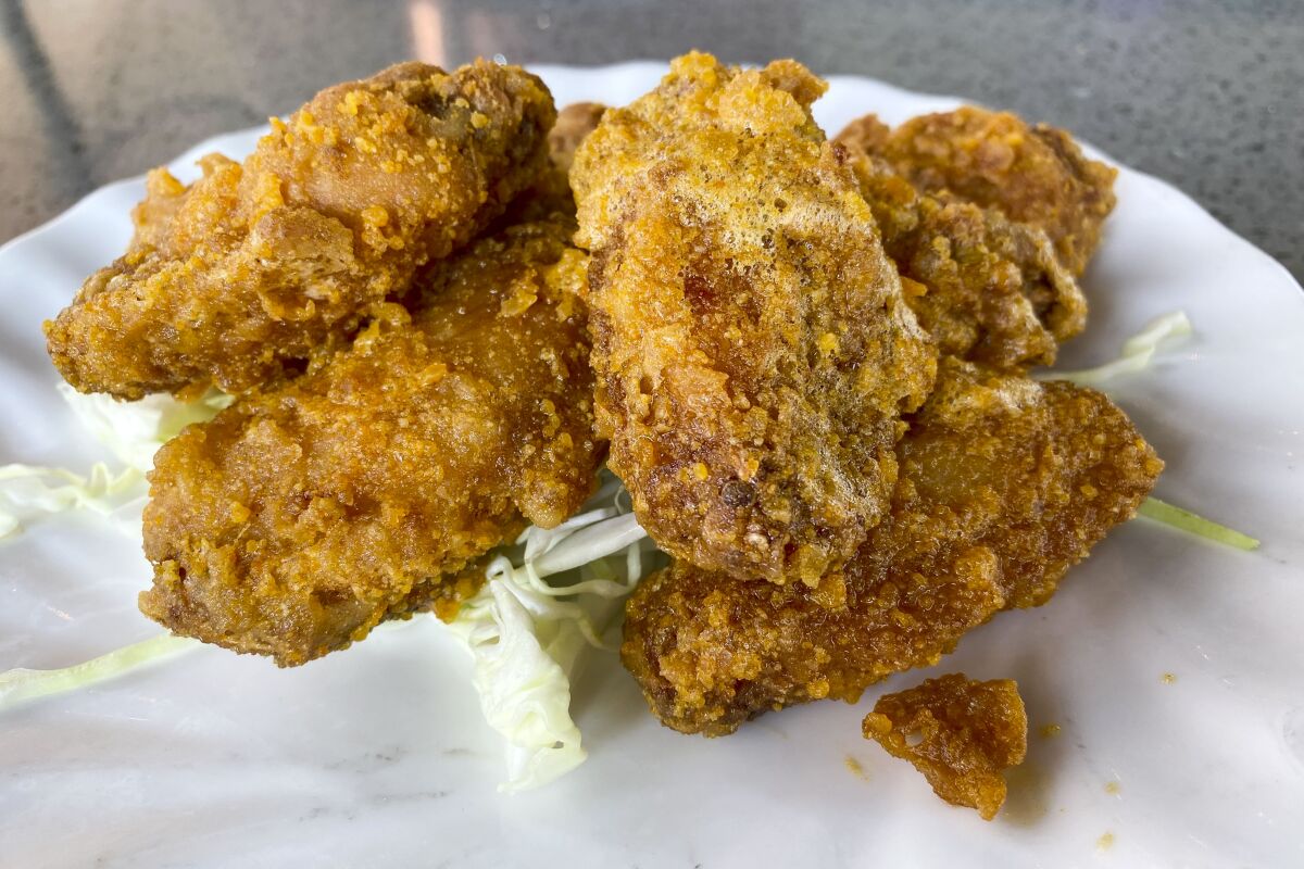 salted egg yolk-covered fried chicken wings in a stack