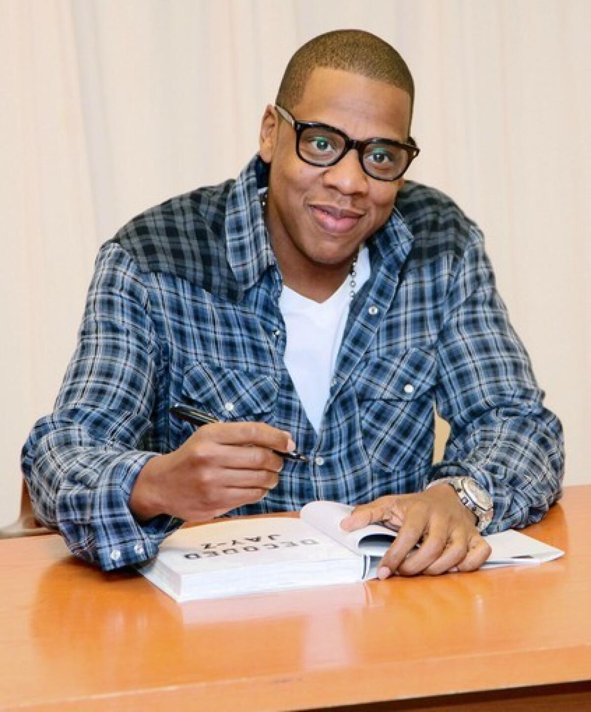 Rapper Jay-Z signs copies of his book "Decoded" in New York last month.