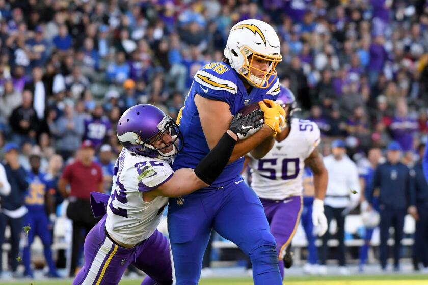 CARSON, CALIFORNIA - DECEMBER 15: Hunter Henry #86 of the Los Angeles Chargers makes a catch for a first down in front of Harrison Smith #22 of the Minnesota Vikings during a 39-10 Vikings win at Dignity Health Sports Park on December 15, 2019 in Carson, California. (Photo by Harry How/Getty Images)
