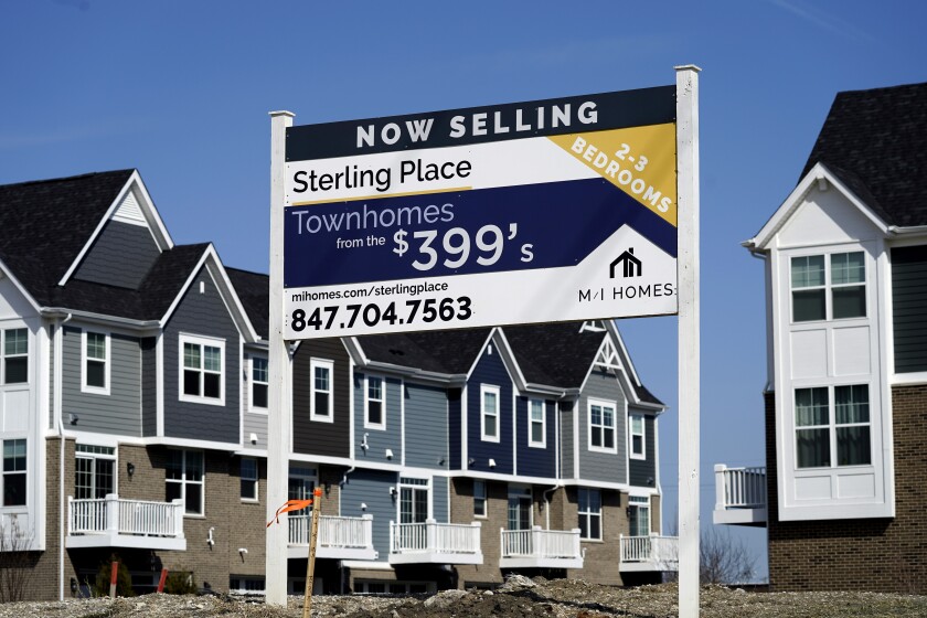 An advertising sign for building land stands in front of a new home construction site in Northbrook, Ill., Sunday, March 21, 2021. The red-hot U.S. housing market is widening the gap between what a home is objectively worth and what eager buyers are willing to pay for it. Fierce competition amid an ultra-low inventory of homes on the market is fueling bidding wars, prompting a growing share of would-be buyers to sweeten offers well above what sellers are asking. (AP Photo/Nam Y. Huh)