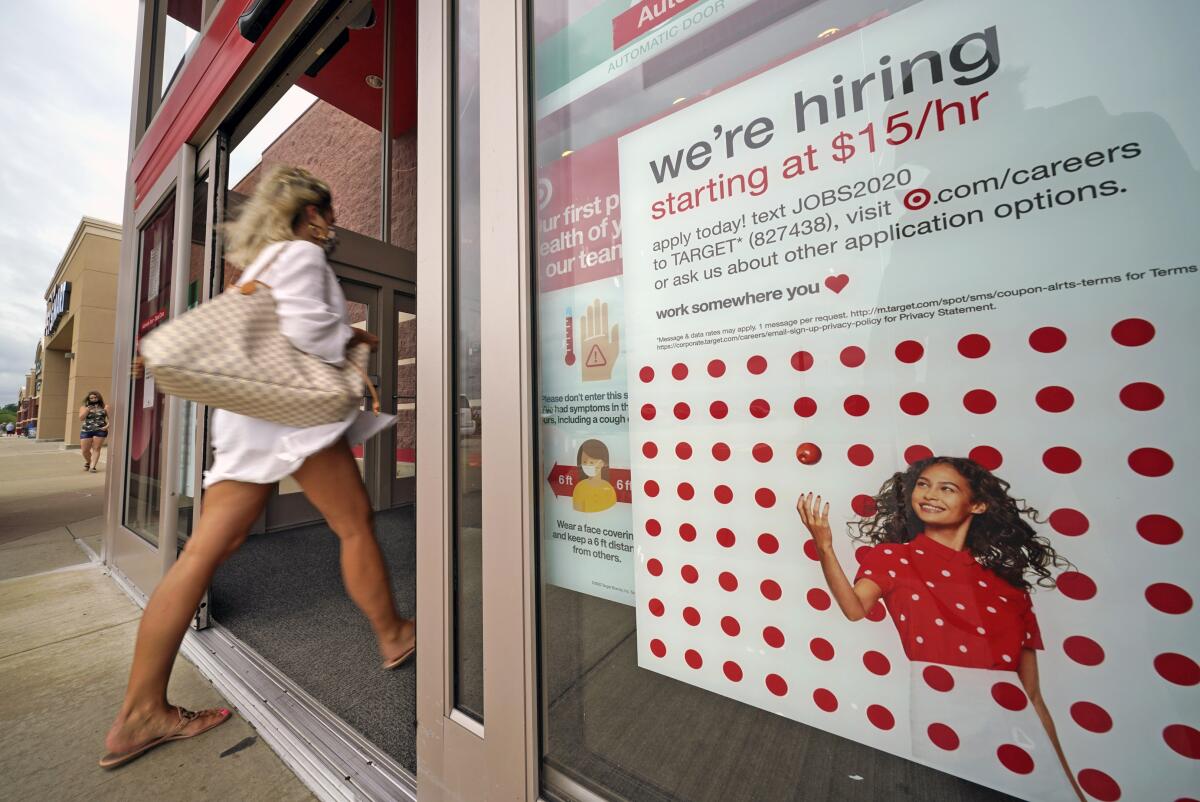 A help-wanted sign hangs on the door of a Target store in Uniontown, Pa.